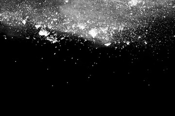 White powder explosion isolated on black background.