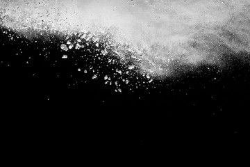 White powder explosion isolated on black background.