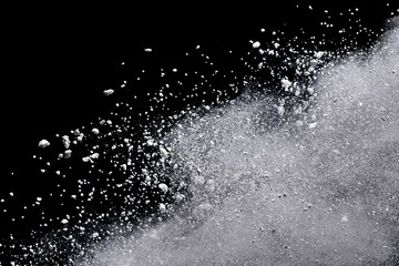 White powder explosion isolated on black background.