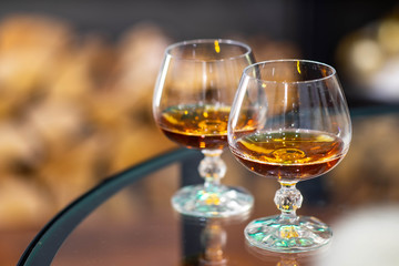 Close-up of two glasses of alcohol drink. Blurred background.