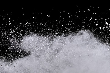 White powder explosion isolated on black background.