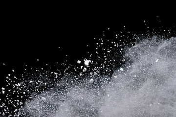 White powder explosion isolated on black background.