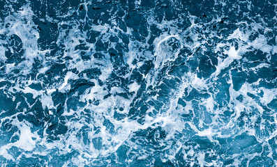 Aerial view of salt ocean waves. Blue water aqua sea background ot texture. Rippled spashing waves.