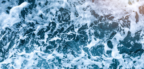 Aerial view of salt ocean waves. Blue water aqua sea background ot texture. Rippled spashing waves wide banner panoramatic photo.