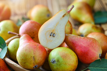Fresh pears on wooden background. Red yellow pear fruits at the table.