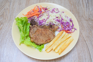 Grilled steak with french fries on the plate