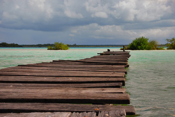 Fototapeta premium Wooden pier on Bacalar seven colours lake, Quintana Roo. Mexico, Yucatan.