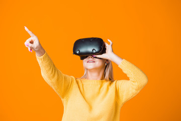 Computer game player uses virtual reality. A young woman in a virtual reality helmet
