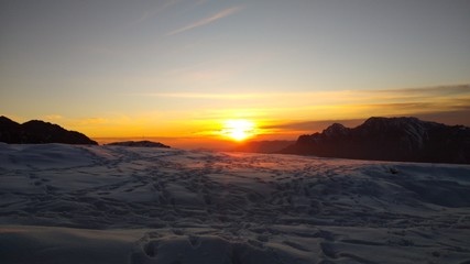 snowfall setting sun