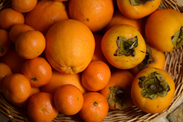 Orange fruits close-up. Oranges, tangerines and persimmons.