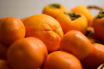 Orange fruits close-up. Oranges, tangerines and persimmons.