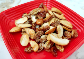 Mix of nuts and dried fruits. Gold pistachios, cashews, Raisin, almonds. Food background.