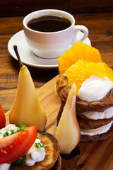 Fresh breakfast, fruit and coffee od wooden desk