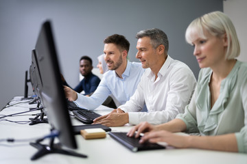 Manager Assisting His Staff In Office