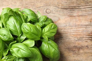 Fresh basil on wooden table, top view