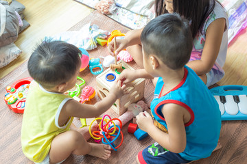Group of baby friend playing toy together in living home