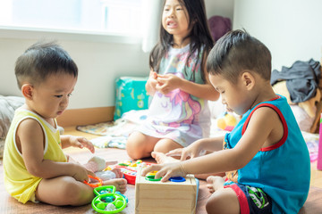 Fototapeta premium Group of baby friend playing toy together in living home