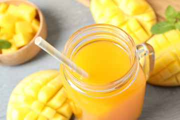 Fresh delicious mango drink on table, closeup