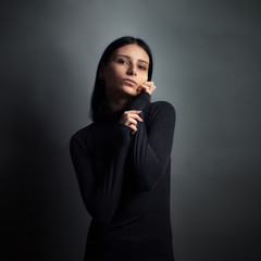 Portrait of young woman on gray background