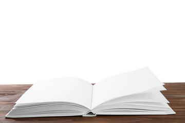 Open old hardcover book on wooden table