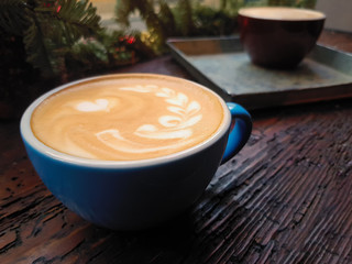 A cup of cappucino on a wood background
