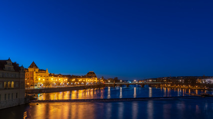 View of river Moldau and national theatre at dawn in Prague.