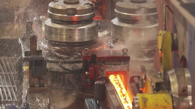 Steel seamless pipe production process. Pipe production, red hot pipes at the factory. Pipe mill