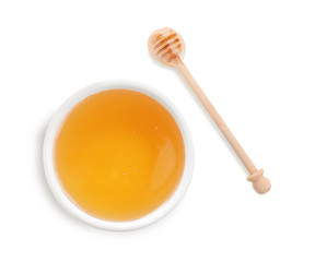 Bowl of organic honey and dipper isolated on white, top view