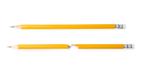 Broken and whole graphite pencils on white background, top view