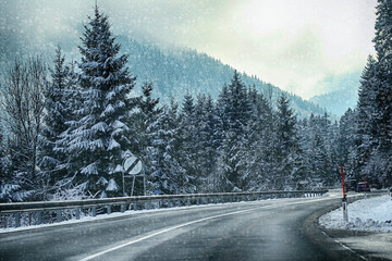 Austria, panoramic winter view along the  alpine route to Pass Thurn with a white snowstorm and the...