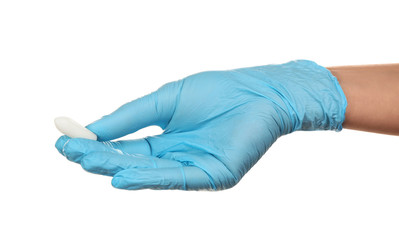 Doctor holding suppository on white background. Hemorrhoid problems
