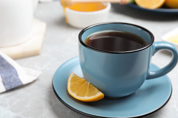 Delicious tea with lemon on marble table