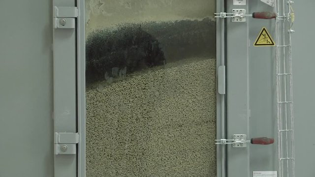 Special corn, meat and vegetable mix from all organic feed for chickens some Pelleted Compound Feed for Cattle. An automated hopper filled with granular compound feed for chickens.