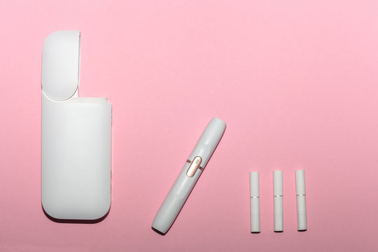 White electronic cigarette isolated on pink background top view