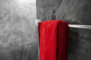 One red towel in bathroom on a dryer. Counter bathroom interior contemporary. Luxury and stylish design bathroom with a concrete style walls.