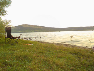 summer morning abandoned fishing rods in the river