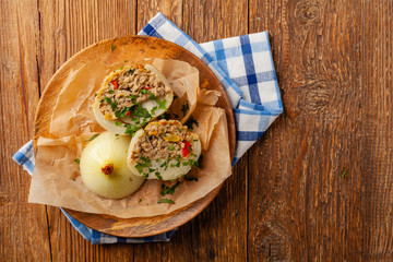 Onion baked with cheese stuffed with minced meat. Top view.  Served in parchment.