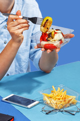 A woman eats food from plastic utensils. The concept of food delivery