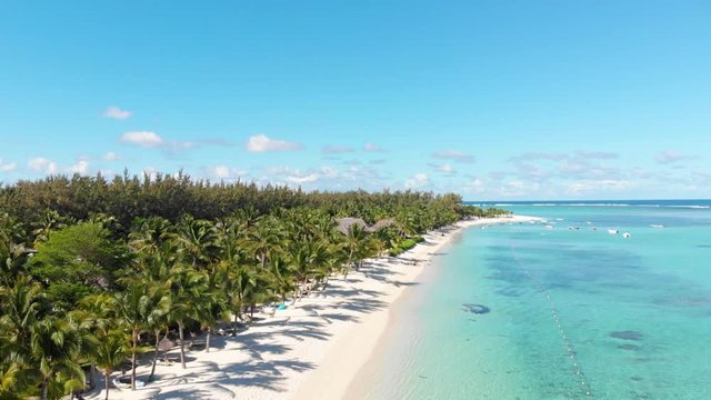 Luxury tropical beach in Mauritius. Beach with palms and blue ocean. Aerial view