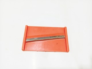 practical tool for peeling carrots, against a white background