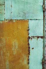 Green painted metal rusted background. Metal rust texture. Erosion metal. Scratched and dirty texture on outdoor rusted metal wall.