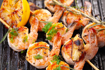 grilled shrimp on skewers. Grilled seafood on skewers with spices, herbs and lemon. delicious prawn. Grill. The iron grill. close up