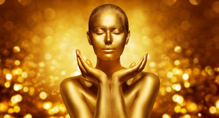 Gold Skin, Beautiful Woman holding Golden Beauty in Hands, Fashion Body Art Make Up