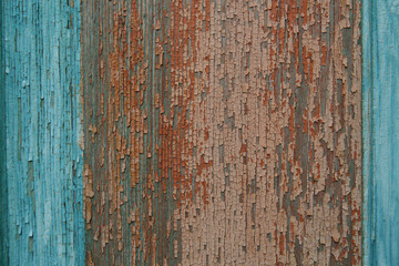 background texture of old natural wooden boards with old multicolor paint with scuffs. Vintage background, pattern, banner. turquoise blue and brown red colors