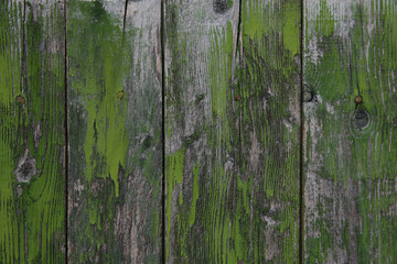 Fototapeta na wymiar old background texture of natural wooden boards with old green paint with scuffs. Vintage background, pattern, banner.