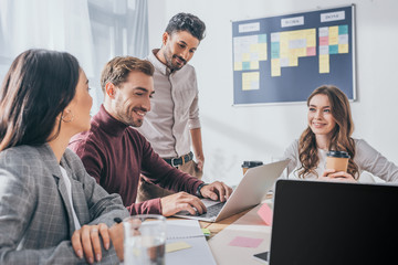 selective focus of happy multicultural businessmen and businesswomen