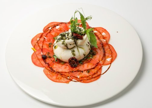 buratto cheese on a plate of vegetables