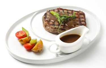 grilled beef steak with sauce and vegetables