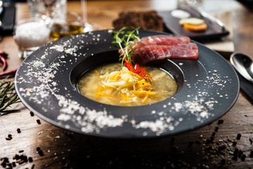Clear Fish soup served in a bowl in restaurant