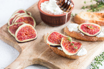 ciabatta or bruschetta with cottage cheese, figs and honey. sandwich with figs and goat cheese